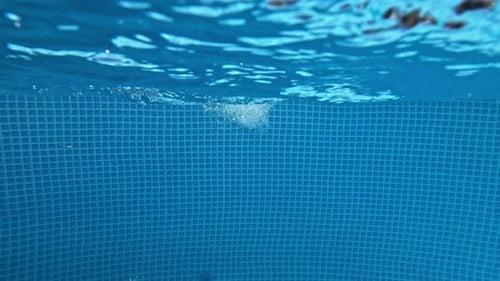 Underwater Splash Beneath Sunlit Pool Surface