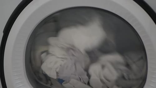 Clothes Spinning Inside Washing Machine Drum at Home
