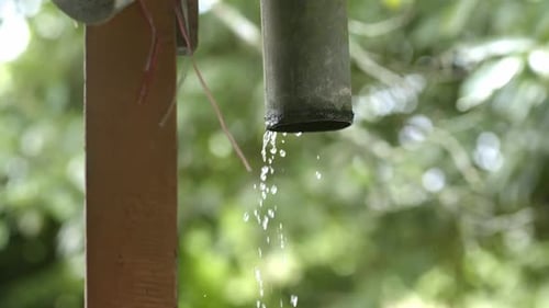 Water pouring out of rain gutter from roof, raindrops out of PVC pipe