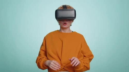 Blonde Woman Using Virtual Reality Futuristic Technology Headset to Play Simulation 3D Video Game