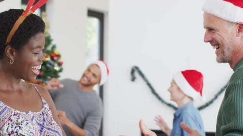 Friends Celebrating Christmas Dancing in Living Room
