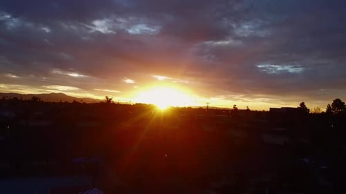 Sun shines through clouds on dawn over horizon, drone shots.
