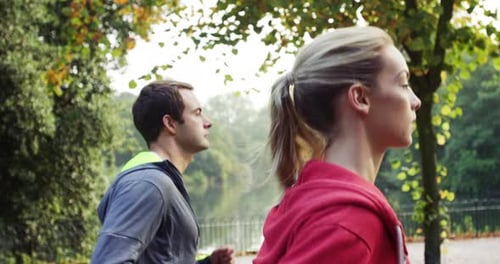 4k video footage of two friends jogging together in the park