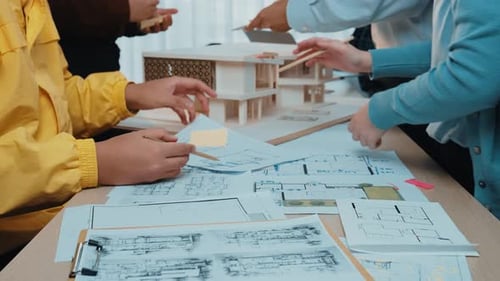 Architects Collaborate on Building Design with Model