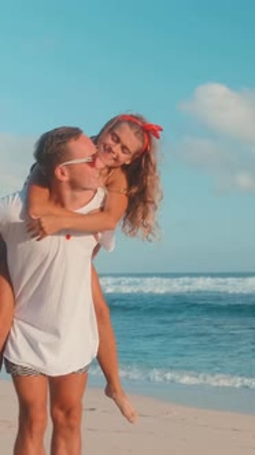Couple Enjoys Beach Day With Playful Moments By the Ocean