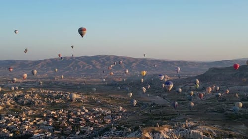 Hot Air Balloons Soaring Over Valley at Sunrise
