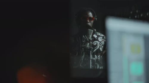 Young Black Singer in Headphones Performing in Recording Booth