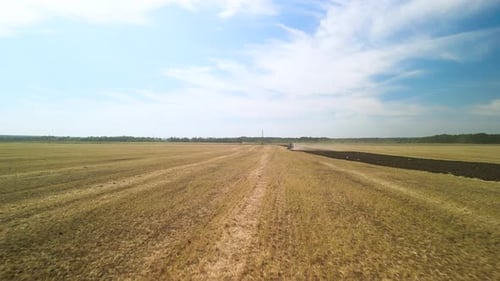 Tractors plowing the field in Ukraine