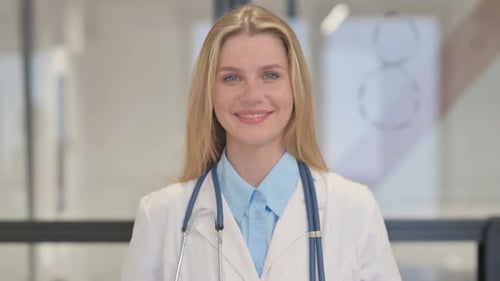 Smiling Young Woman Doctor in Clinic