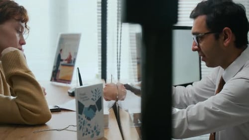 Bank Assistant Helping Woman with Signing Documents in Office
