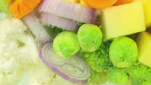 Vegetable mix for making soup in boiling water with air bubbles.