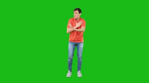 Upset Man Touching Heart and Gesturing Stop in Green Studio