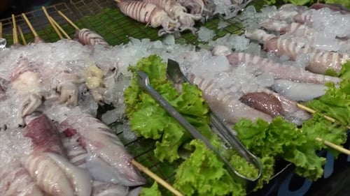 octopus or squid in stick for grill - street food style