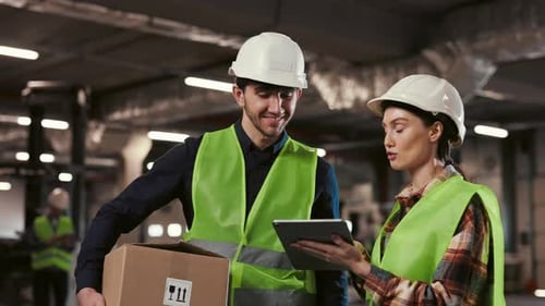 Female Worker Demonstrating Something to Man Using Tablet Engaged in Managing Activities with Male