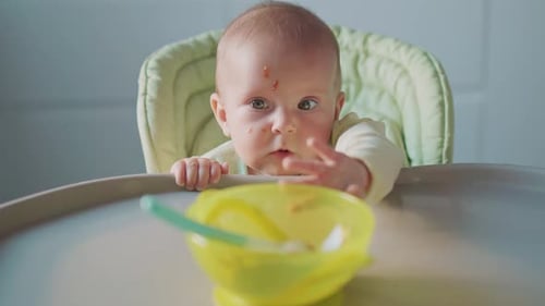 Baby at High Chair with Bowl