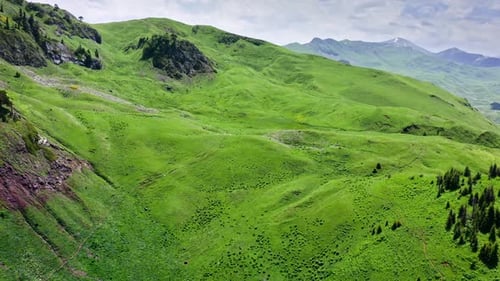 Flying Above Small Highland Lake Among Cliffsides And Green Hills