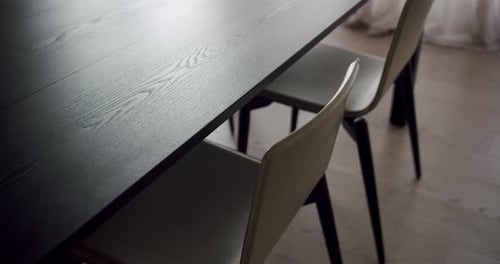 Wood Dining Table and Chairs on Hardwood Flooring in a Dark Room