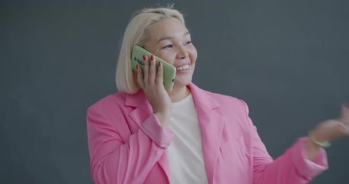 Smiling Woman Talking on Cell Phone Indoors