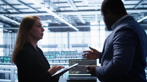 Coworkers in Data Center Replacing Storage Rigs Parts to Improve Performance