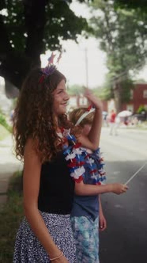 Children Celebrate with American Flags at Parade