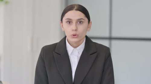 Surprised Woman in Business Suit Looking Worried