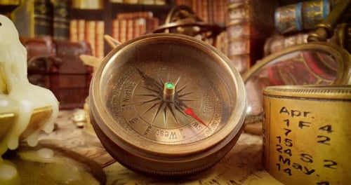 Vintage style travel and adventure. Vintage old compass and other vintage items on the table.