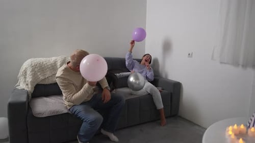 Family Playfully Enjoying Balloons in Home