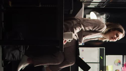 Coworkers at Desk with Laptop in Office