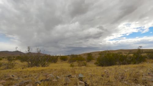 Time lapse clouds over desert brush