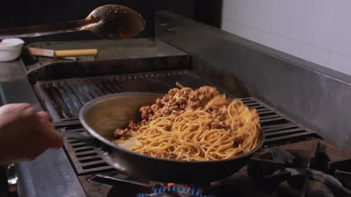 Chef Cooking Spaghetti in Commercial Kitchen
