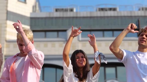 Group of Young Adults Dancing Together on Rooftop
