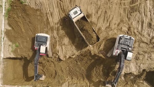 Aerial View of Excavators and Dump Truck Digging