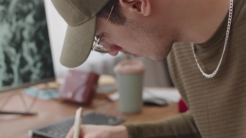 Young Adult Working on Music Composition