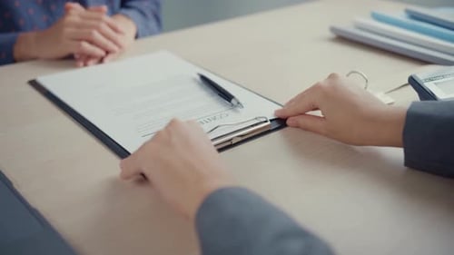 Closeup hand signing contract at office