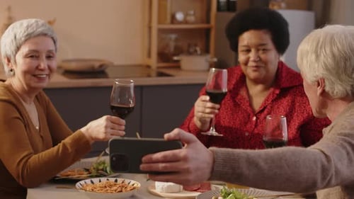 Friends Toast Wine, Take Selfie at Dinner Table