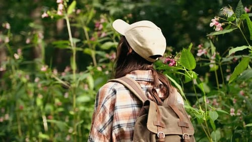 Young Caucasian Woman with Backpack Traveling in the Forest The Girl is Feeling Fresh Wonderful