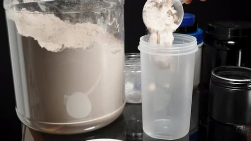 Pouring Protein Powder into Shaker for Health