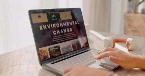 Typing on Laptop Showing Environmental Change Website