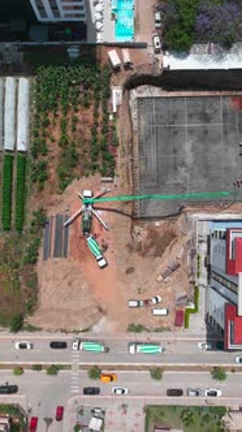 Vertical Video Busy Construction Site in Timelapse Shows Builders and Heavy Equipment Advancing