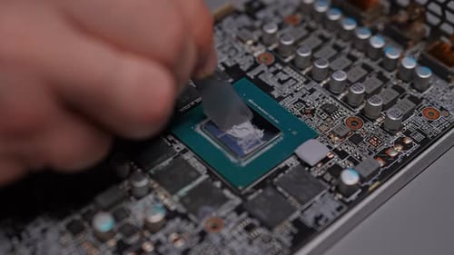 Closeup Top View Precise Application of Thermal Paste to GPU Chip for Optimal Heat Dissipation and