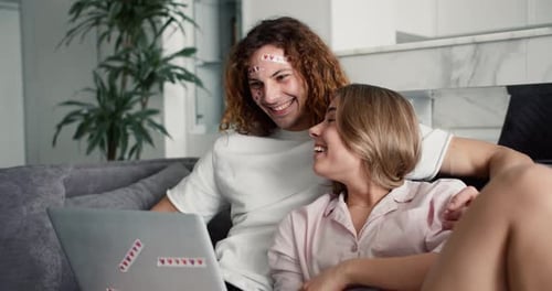 Happy Couple Video Chatting from Couch at Home