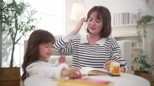 Young Woman and Child Drawing Together at Home