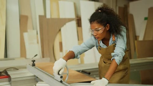 Side view carpenter or woodworker or charpentier woman bring wooden planks and set to fit frame