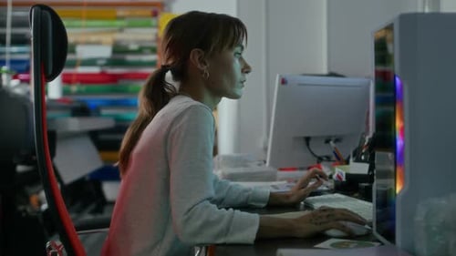 Woman Working On Computer In Workshop