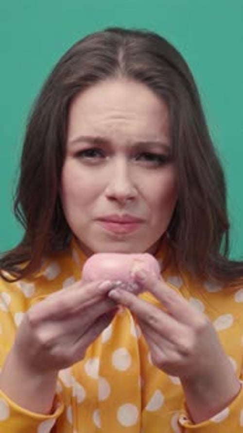 Woman Eating a Delicious Pink Donut Close-Up