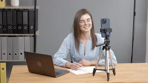 Young Woman Recording Herself at Her Desk