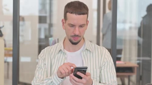 Excited Man Celebrating Good News on Smartphone