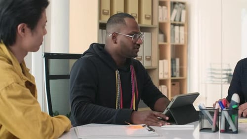 Business Meeting with Tablet in Bright Office