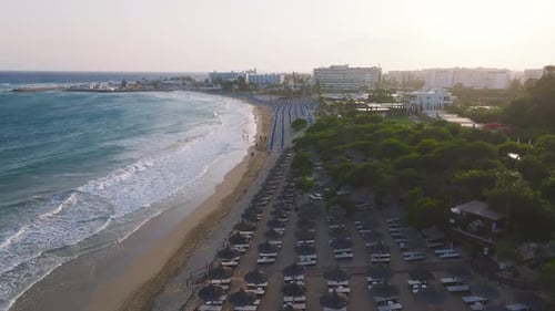 Aerial View of Ayia Napa Beach with Sun Loungers and Turquoise Waves
