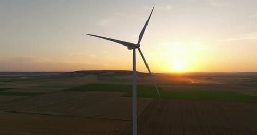 Silhouette of a Windmill in the Sun Aerial Close Up Shot of Wind Mills Rotating By the Force of the